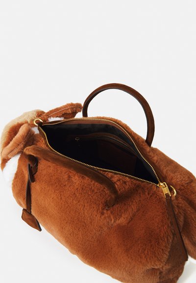 Borsa a mano in peluche marrone con manici marroni scuri e zip dorata, mostrata parzialmente aperta che rivela tasche interne.