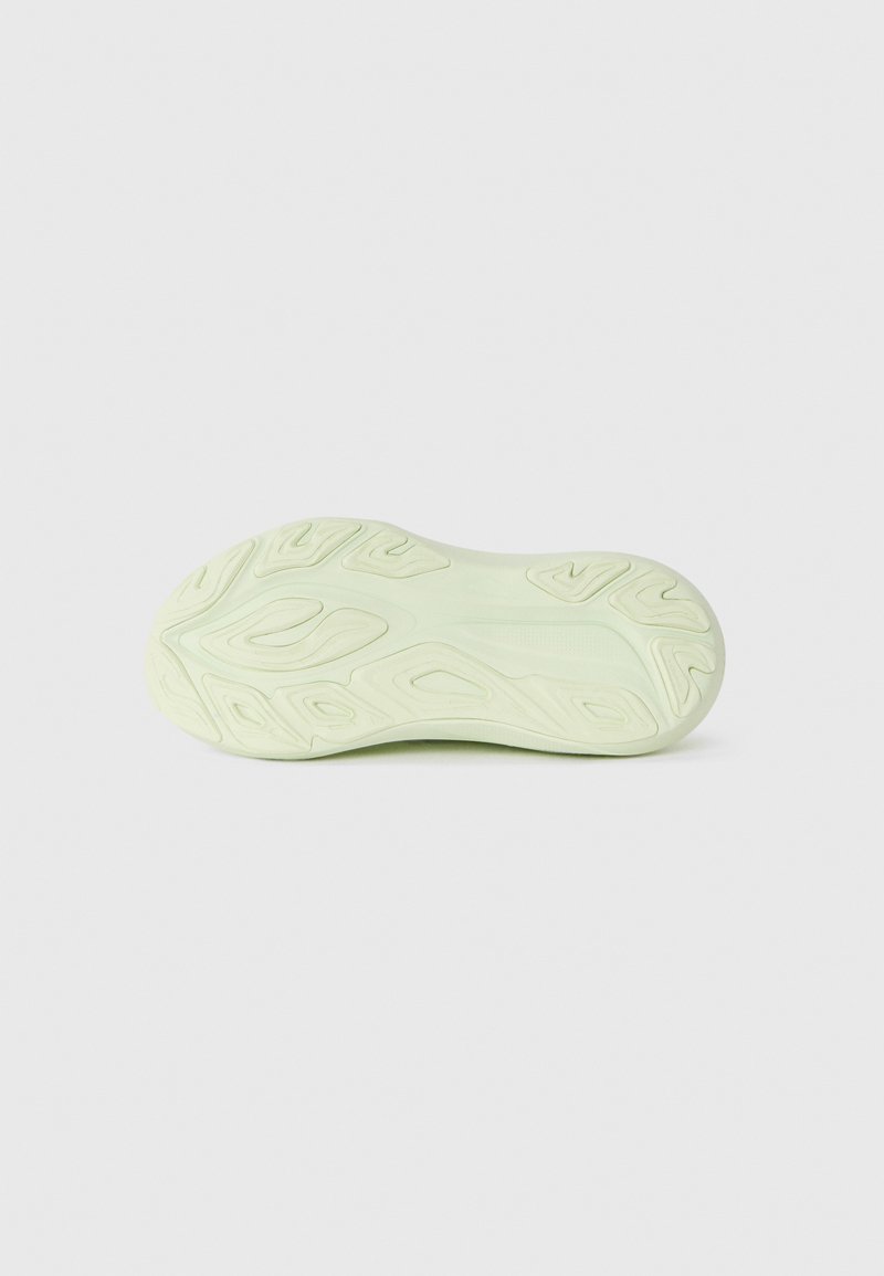 Light green rubber sneaker sole with textured patterns and grooves for traction. Smooth finish with rounded edges.