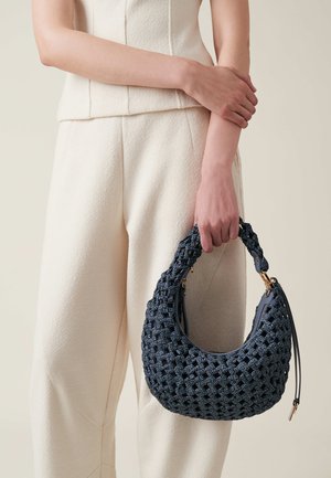 Knitted dark blue handbag with a textured surface and woven design, featuring a curved handle and gold hardware accents.