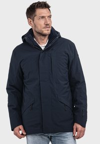 Marineblaue, wasserdichte Jacke mit Kapuze, Frontreißverschluss und Druckknopfverschluss, seitlichen Taschen und einem strukturierten Stoff für Isolierung.