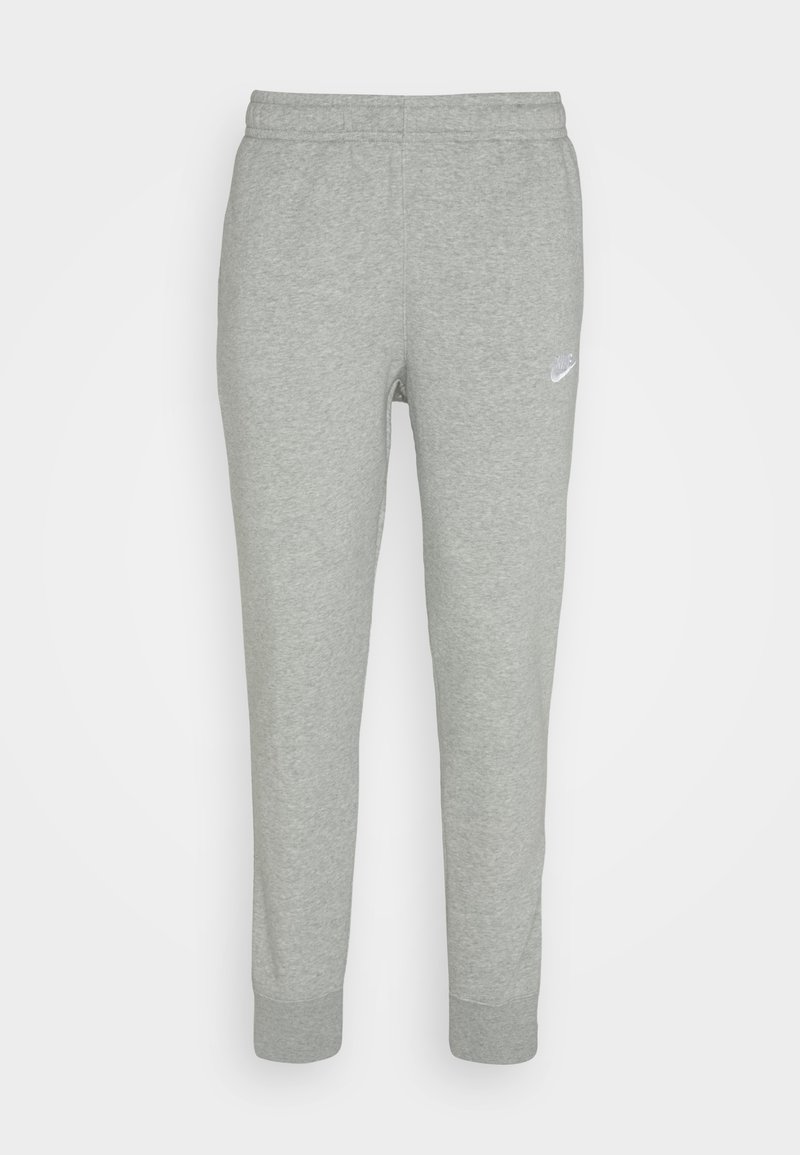Pantalons de survêtement gris en tissu doux, avec une coupe fuselée, une taille élastique et un petit logo Nike blanc sur la cuisse gauche.