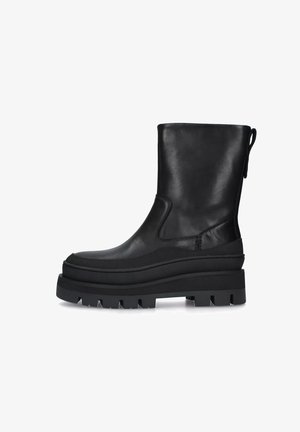 Stivale alla caviglia in pelle nera con una suola a piattaforma spessa, punta rotonda e finitura liscia. Presenta una cucitura minimale e un tassello sul retro.