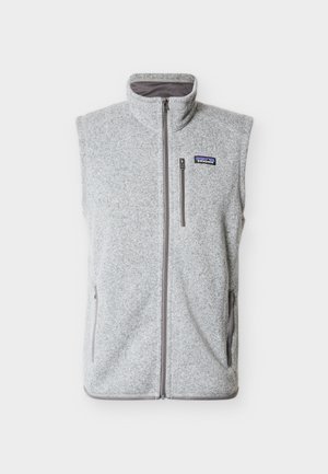 Ανοιχτό γκρι γιλέκο από φλις χωρίς μανίκια με μπροστινό φερμουάρ, τσεπάκι στο στήθος με φερμουάρ και πατς με το λογότυπο της Patagonia στο αριστερό μέρος του στήθους.