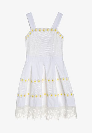 Biała sukienka z koronkową fakturą, żółty haftowany stokrotkami oraz rozkloszowanym dołem. Posiada regulowane ramiączka oraz koronkowe wykończenie na dolnym brzegu.