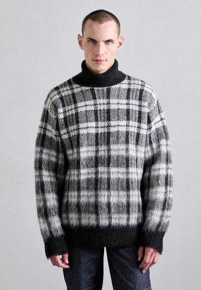 Black and white plaid sweater with a high, ribbed turtleneck. Made of soft texture, featuring gradient shading towards the bottom and wide sleeves.