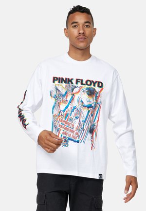 White long-sleeve shirt featuring a colorful Pink Floyd graphic on the front, with the text "Knebworth, Hertfordshire, UK, June 30, 1990" included.