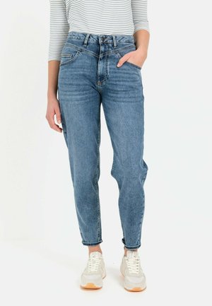 High-waisted, light blue denim jeans with a relaxed fit, five pockets, and subtle fading; paired with white sneakers on a neutral background.