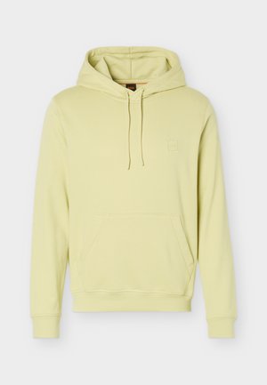 Sweat à capuche jaune clair avec poche kangourou à l'avant, capuche avec cordon de serrage, et logo discret embossé sur le côté gauche de la poitrine.