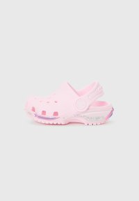 Light pink clogs made of soft plastic, featuring ventilation holes, rounded toe, a heel strap, and a decorative glittery rainbow accent.