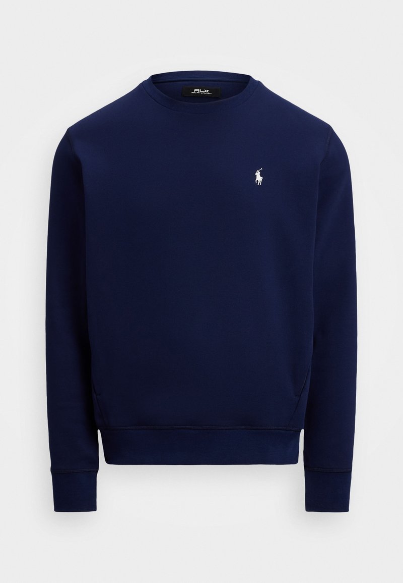 Sweatshirt bleu marine en tissu lisse, avec un col rond, des manches longues et un petit logo blanc sur la poitrine. Poignets et ourlet côtelés.