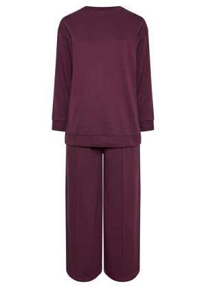 Burgundy loungewear-setti, jossa on pitkähihaiset paita ja leveälahkeiset housut. Neulottu kangas, pehmeä rakenne, rento istuvuus ja ribbaus hihoissa.