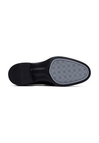 Schwarze Schuhsohle mit Gummigrip-Rillen, ausgestattet mit einer grauen gemusterten Einlage mit kleinen Rauten. Glatte schwarze Umrandung.