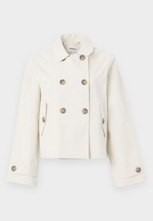 Trench-coat court couleur crème avec un design croisé à double boutonnage, quatre grands boutons dorés, et des poches latérales. Tissu lisse avec un léger brillant.