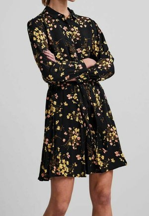 Schwarzes Kleid mit Blumenmuster in Gelb und Pink. Mit Kragen, langen Ärmeln und tailliertem Schnitt für einen ausgestellten Saum.