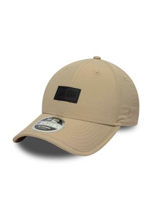 Beige New Era 9FORTY adjustable cap with curved brim and black logo patch on front, displayed against white background.