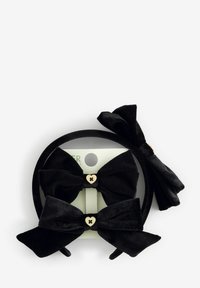 Set di accessori per capelli in velluto nero, che include due fiocchi con accenti di cuore dorato e un cerchietto abbinato. Texture liscia, design versatile.
