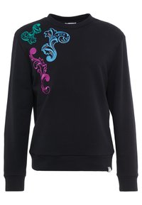 Sweat-shirt noir à manches longues avec des motifs floraux brodés vibrants en vert, bleu et violet sur l'épaule gauche.