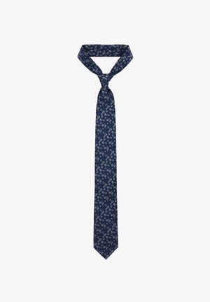 Granatowy krawat z materiału o wzorze, w którym występują jasne kwiatowe elementy, zakończony ostrym końcem i tradycyjnym węzłem.