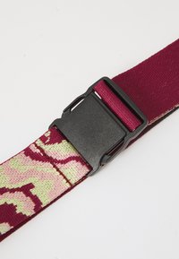 Belt with a maroon base and a pink and green camo pattern. Features a matte black plastic buckle. Fabric is woven for durability.