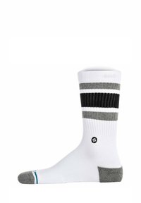 Calze di cotone bianche con motivo a strisce grigie e nere, bordo a costine e tallone rinforzato. Presenta un piccolo logo nero sul lato.
