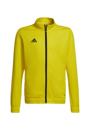 Gelbe Zip-Jacke aus glattem Stoff mit Stehkragen und schwarzem Adidas-Logo auf der oberen linken Seite. Verfügt über seitliche Taschen und einen schwarzen Reißverschluss.
