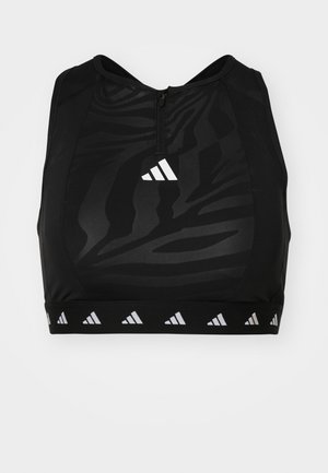 Soutien-gorge de sport noir avec fermeture éclair à l'avant, présentant un motif subtil, des coutures renforcées et une bande de marque contrastante au niveau de l'ourlet.