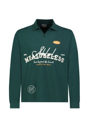 Dark green long-sleeve polo shirt with collar, white and orange text reading "MEASURELESS," "live beyond the limit," and "always stay bold."