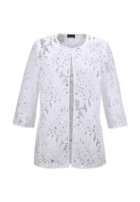 Weißer häkelbarer Cardigan aus Spitze mit Dreiviertelärmel und offenem Schnitt. Verfügt über filigrane Blättermuster und eine lockere Passform.