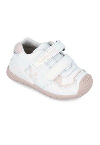 Zapatilla sintética blanca para niños con detalles rosas, que cuenta con dos correas de velcro ajustables, una puntera redonda y una suela texturizada para mayor agarre.