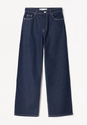 Mørkeblå vidde jeans med forlommer, bæltestropper og knaplukning i taljen.