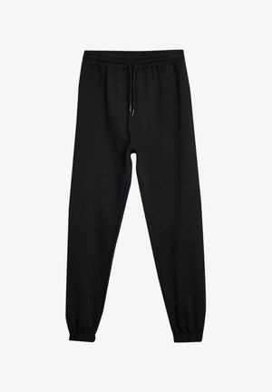 Schwarze Sweatpants aus weichem Stoff, mit einem elastischen Bund und Kordelzug, schmal zulaufenden Bündchen und ohne sichtbare Muster oder Akzente.