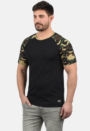 Black t-shirt featuring camo-patterned sleeves and a ribbed crew neckline. Made from soft fabric, with a label at the hem.