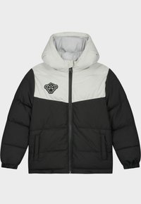 Veste matelassée noire et blanche avec capuche, fermeture éclair à l'avant, poches latérales, poignets élastiques et un patch logo noir sur la poitrine gauche.