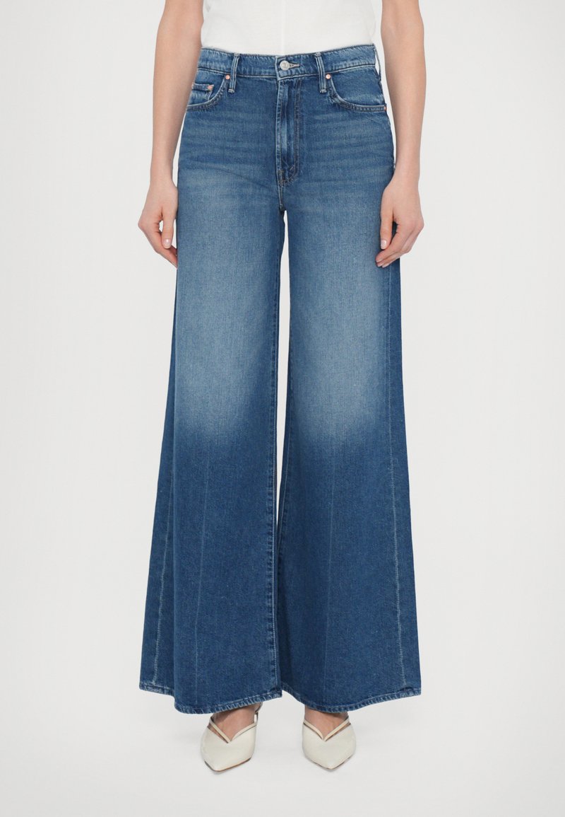 Wide-leg blue denim jeans featuring a high waist, faded finish, and subtle stitching details. Smooth texture with a structured shape.