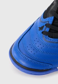 Blue leather sneaker with black accents, designed with a rounded toe, perforated detailing, and textured surface; features black laces.