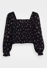 Blouse noire courte avec un décolleté carré, un buste élastique froncé et des manches bouffantes ornées d'un motif floral en vert, rose et blanc.