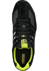 Schwarzer Sportschuh aus Wildleder und Mesh-Materialien, mit weißen Streifen, neon-grünen Akzenten und einem gepolsterten Innenraum, einschließlich einer markierten Einlage.