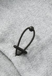 Gray fleece fabric with a textured finish, featuring a black elastic cord with a round toggle and stopper for secure adjustment.