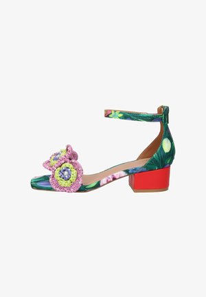 Sandalo con tacco basso con motivo floreale verde, tacco a blocco rosso, cinturino alla caviglia e decorazioni floreali rosa all'uncinetto sulla fascia delle dita.