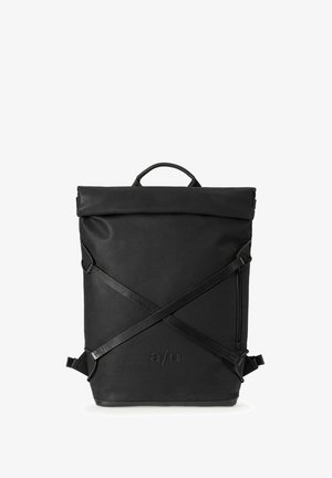 Hands opening a black backpack showing its light gray interior with multiple compartments and a padded laptop sleeve.