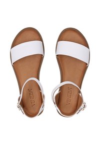 Witte platte sandalen met een brede band en een verstelbare enkelgesp. Bruine textuur voetbed met subtiele branding aan de binnenkant.