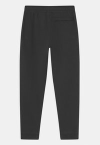 Black sweatpants made of soft fabric, featuring an elastic waistband and a single back pocket with a subtle seam detail.