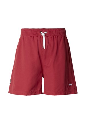 Shorts à taille élastique rouge avec cordon de serrage blanc et petit logo "UNFAIR" sur la partie inférieure de la jambe droite, présentés sur un fond blanc.