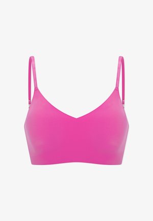 Bright pink seamless bra with thin adjustable straps and a smooth, lightly padded design.