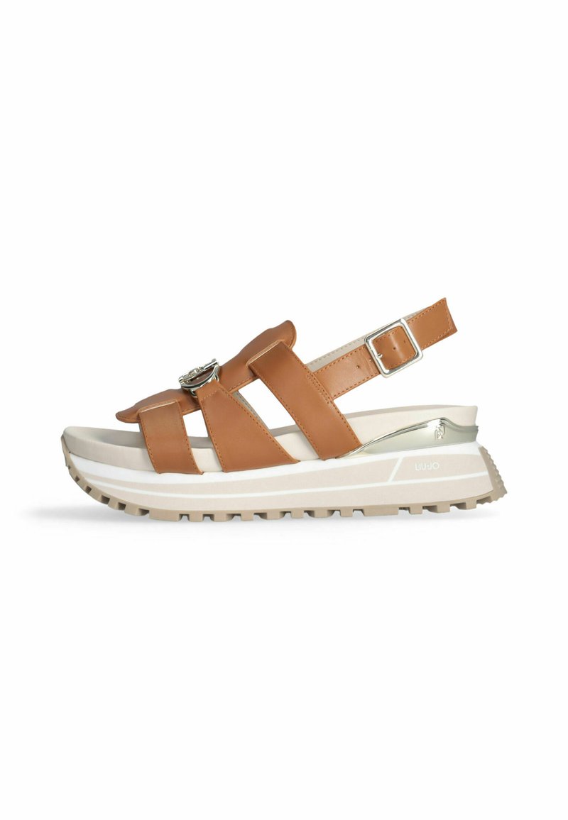Brown leather sandals with two wide straps and an adjustable heel buckle, featuring a thick white and beige platform sole with a textured grip.