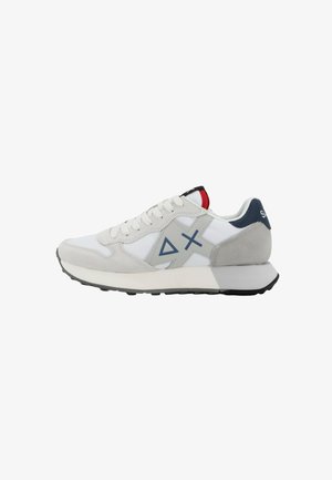 Wit- en grijze lage sneaker met veters aan de voorkant, blauw geometrisch logo op de zijkant, zwarte zool en rood accent op de tong.