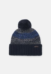 Knit beanie hat featuring a pom-pom on top, dark blue and grey woven pattern, and a ribbed dark blue cuff with a label.