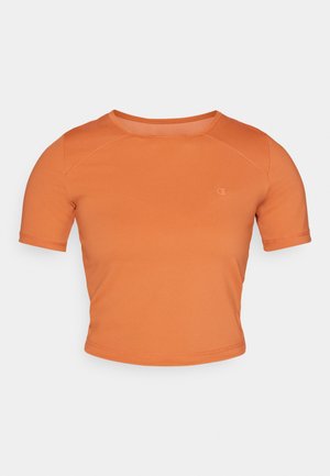 Trumpas, trumpomis rankovėmis oranžinis marškinėliai, pagaminti iš lygaus audinio. Turi apvalią iškirptę ir mažą logotipą priekyje kairėje pusėje.