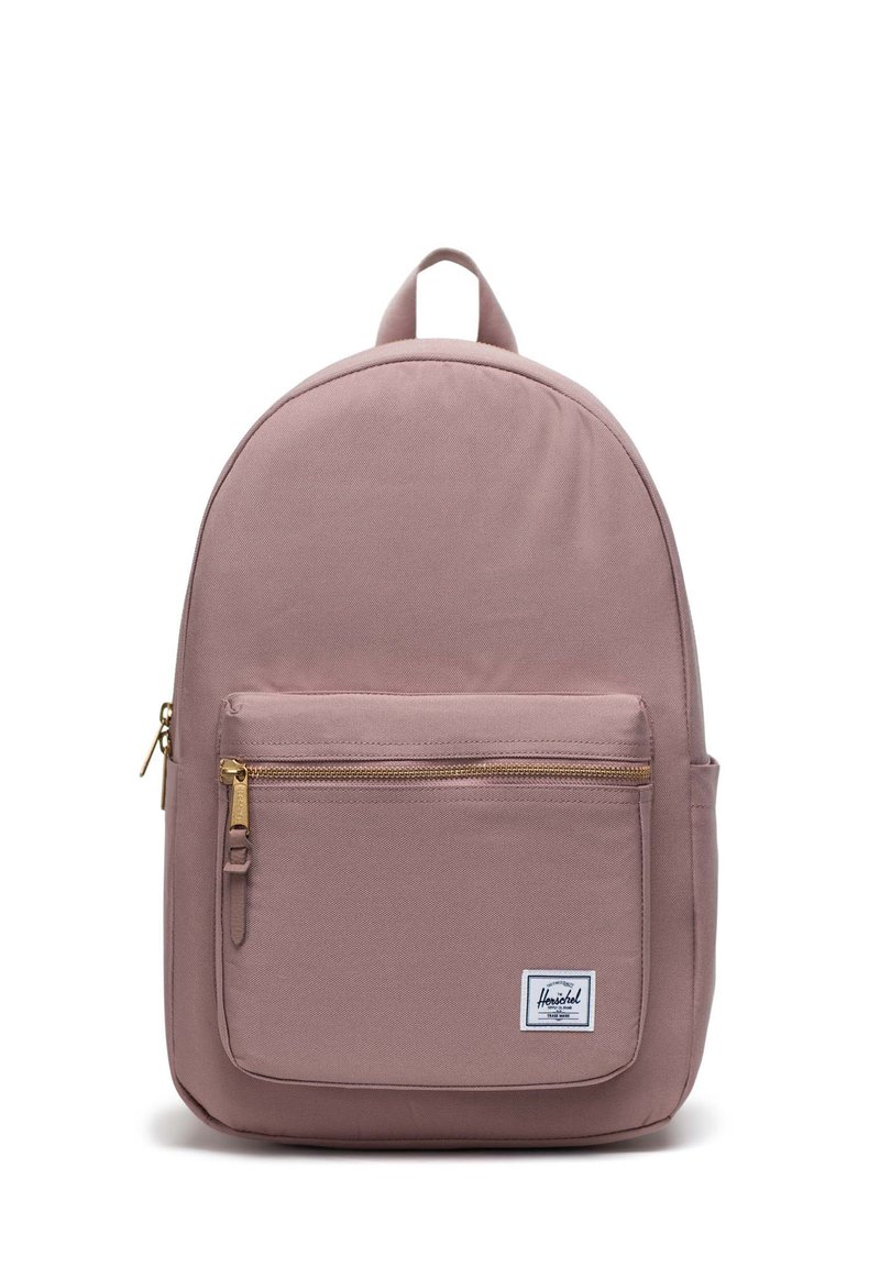 Zaino in tessuto rosa con forma arrotondata, tasca frontale con zip e una patch del logo bianca. Dotato di manico superiore e spallacci regolabili.