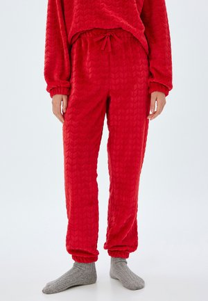 Rode, gemarmerde fleece broek met een zigzagpatroon, elastische tailleband met trekkoord en aansluitende boorden bij de enkels.